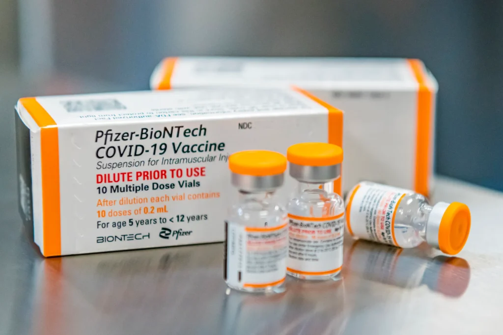 A box of covid vaccines sits on a table.