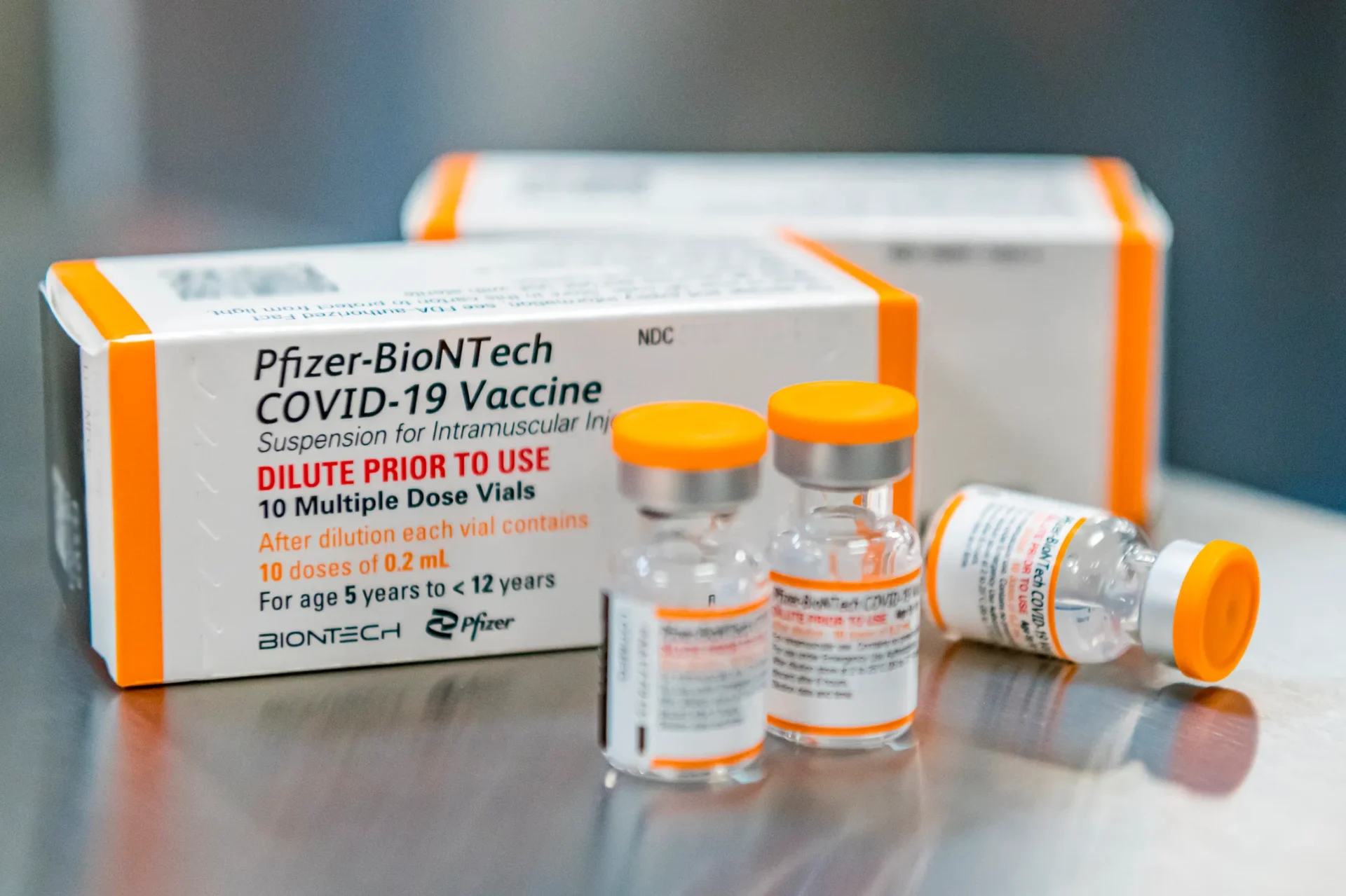 A box of covid vaccines sits on a table.