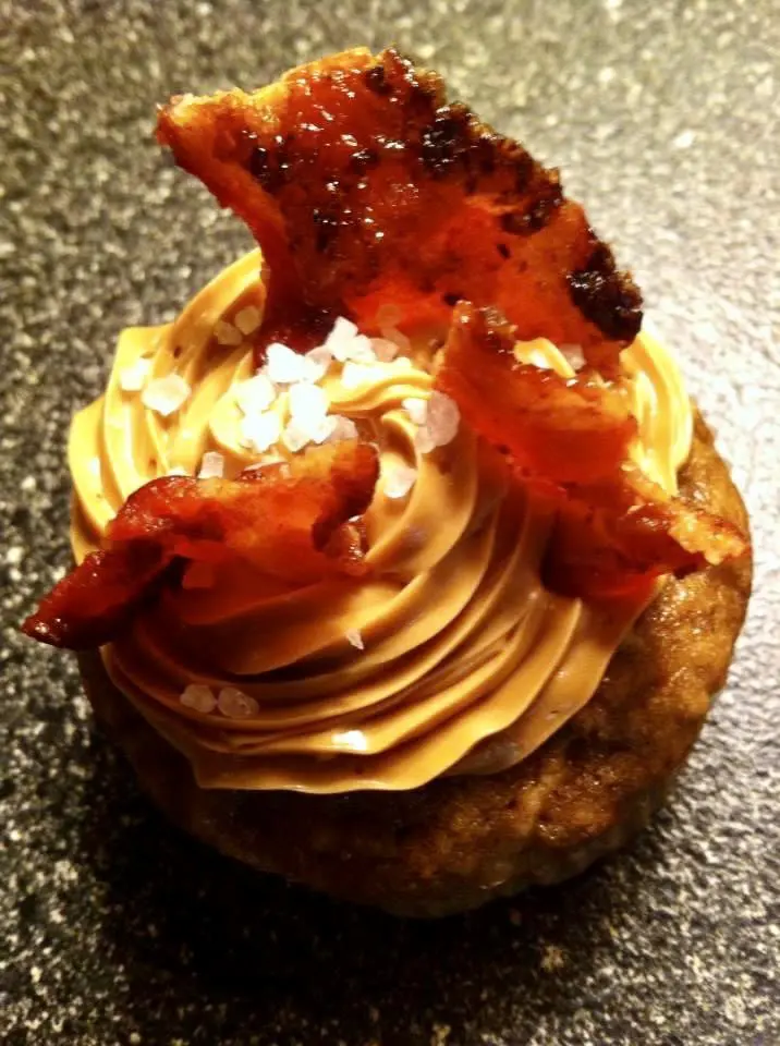 A cupcake topped with bacon and peanut butter.