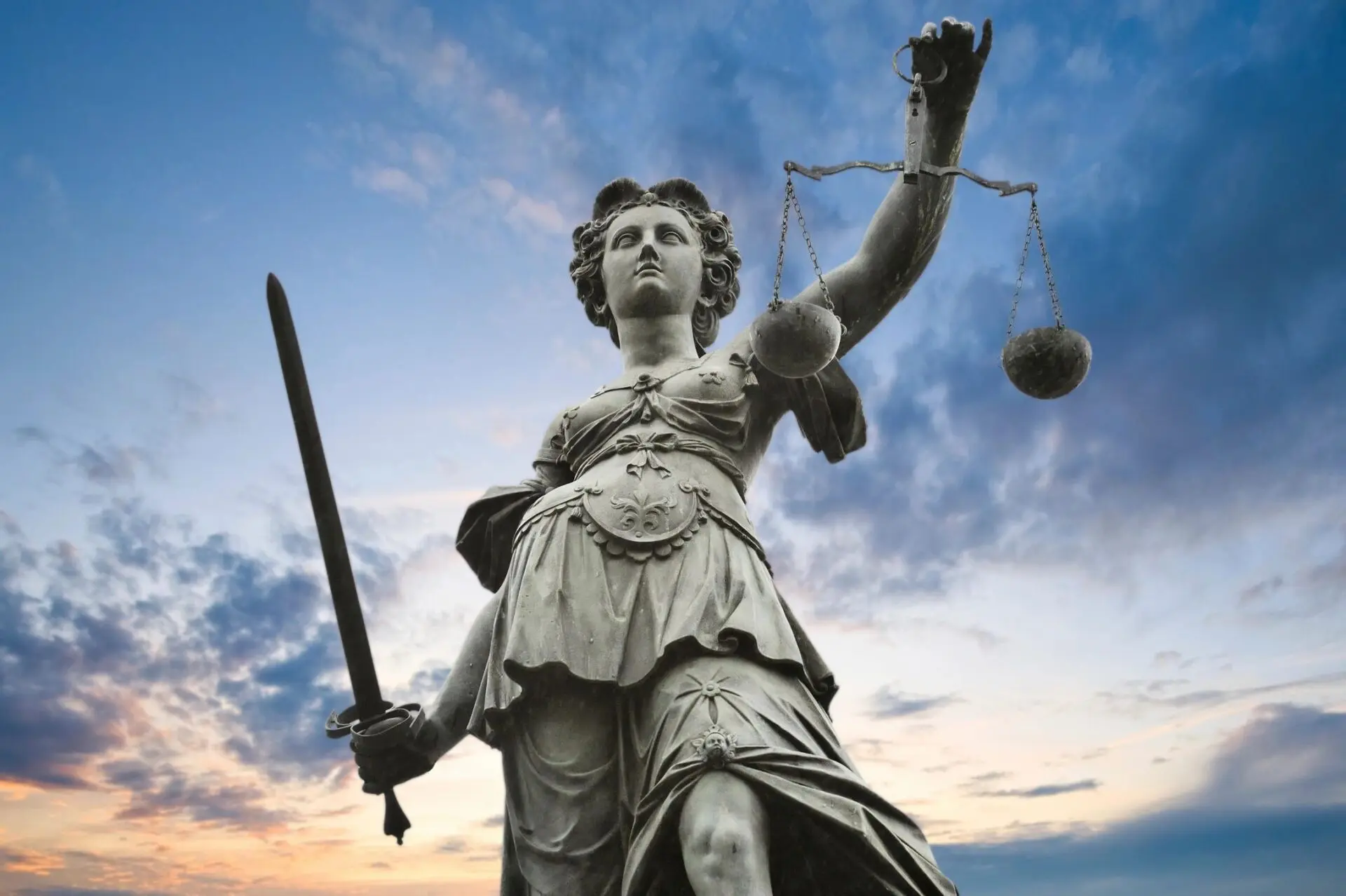 A statue of lady justice holding a sword and scales.