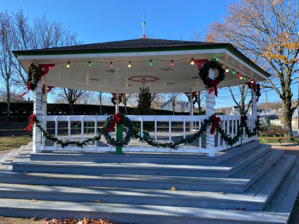 A gazebo in a park with christmas decorations.