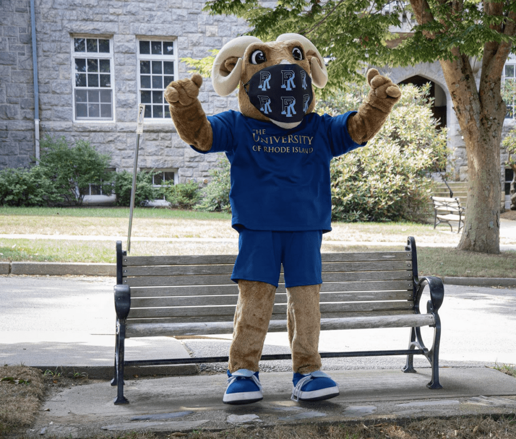 A mascot wearing a blue shirt on a bench.