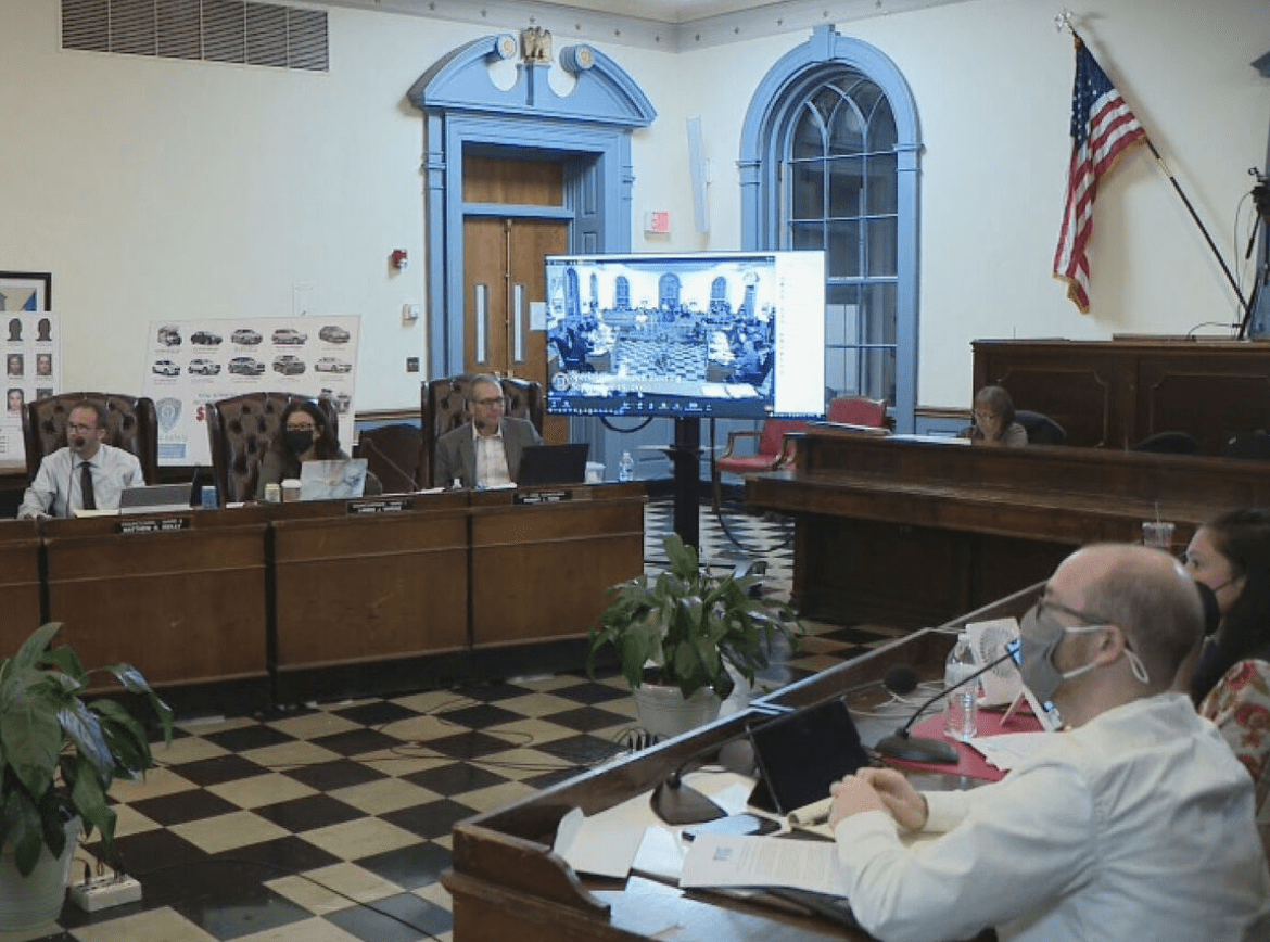 A group of people sitting at a table in a courtroom.