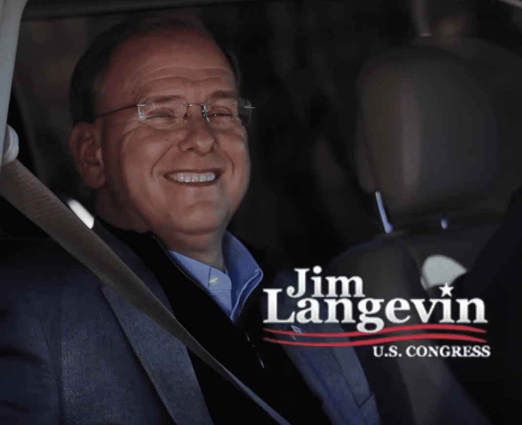 Jim langevin in a car with a smile on his face.