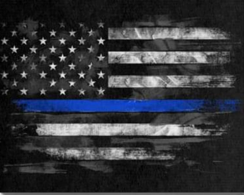 A thin blue line american flag on a black background.