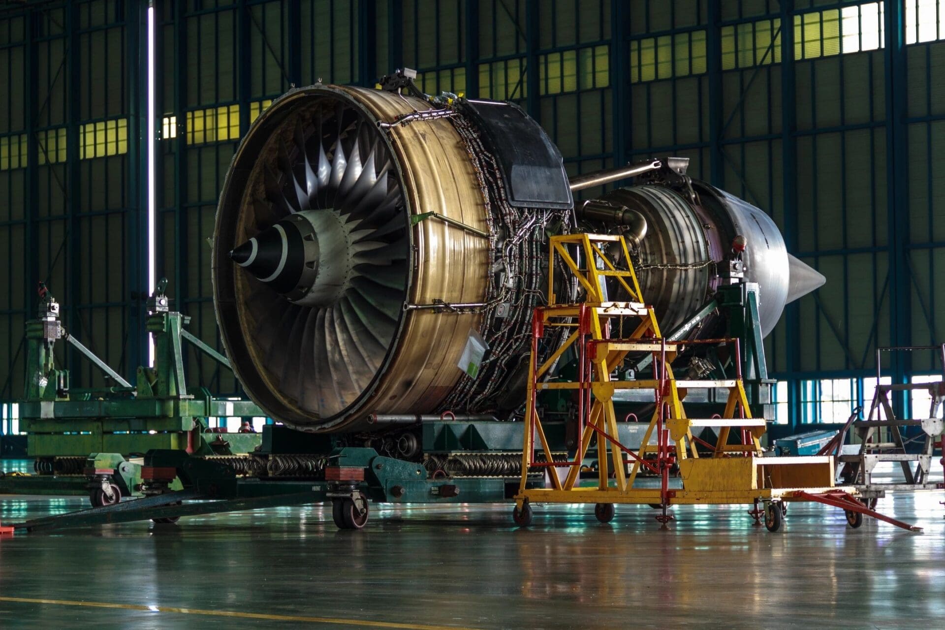 A large jet engine sitting in a hangar.