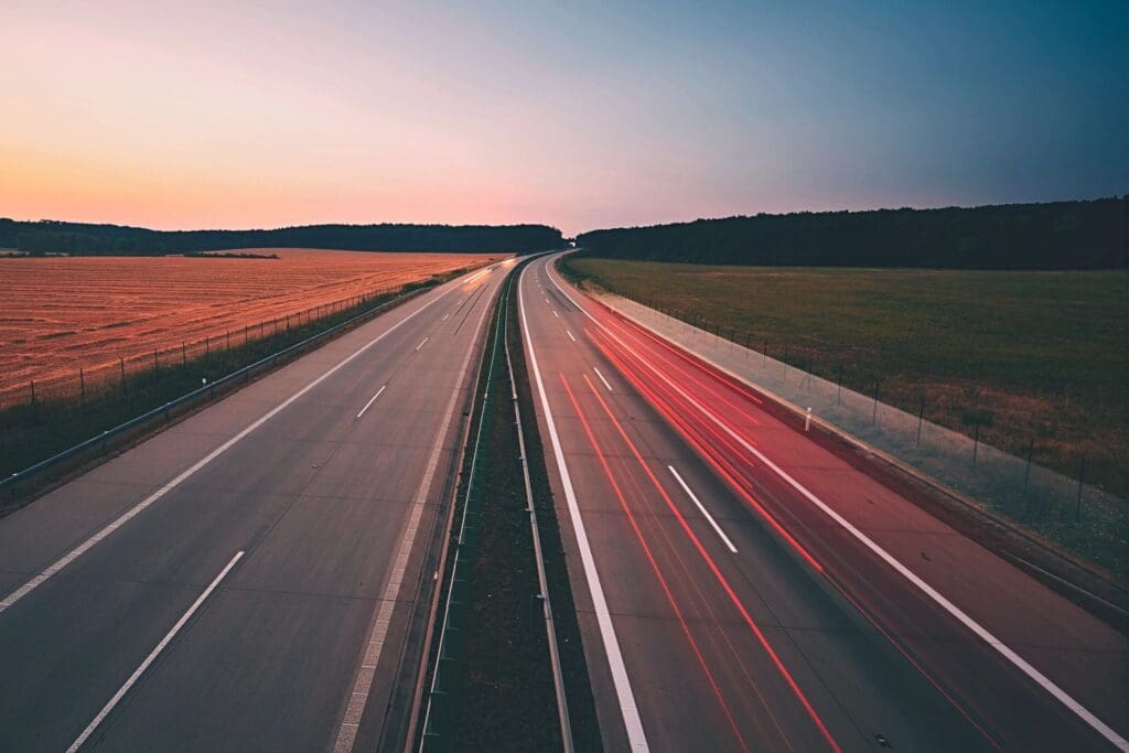 An aerial view of a highway at sunset.