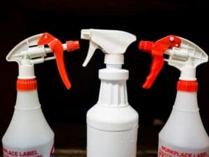 Three spray bottles with a label on them.
