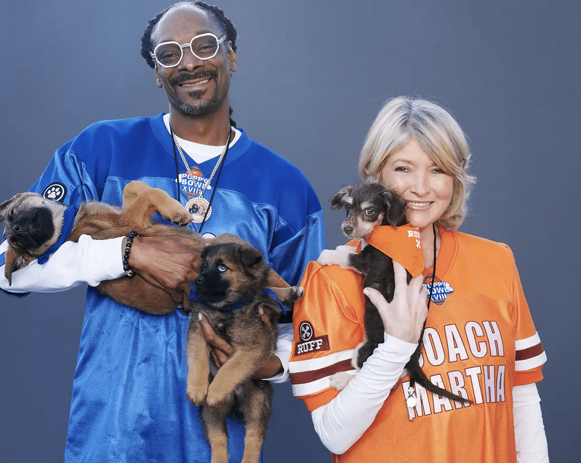 Snoop dogg and his wife pose with puppies.