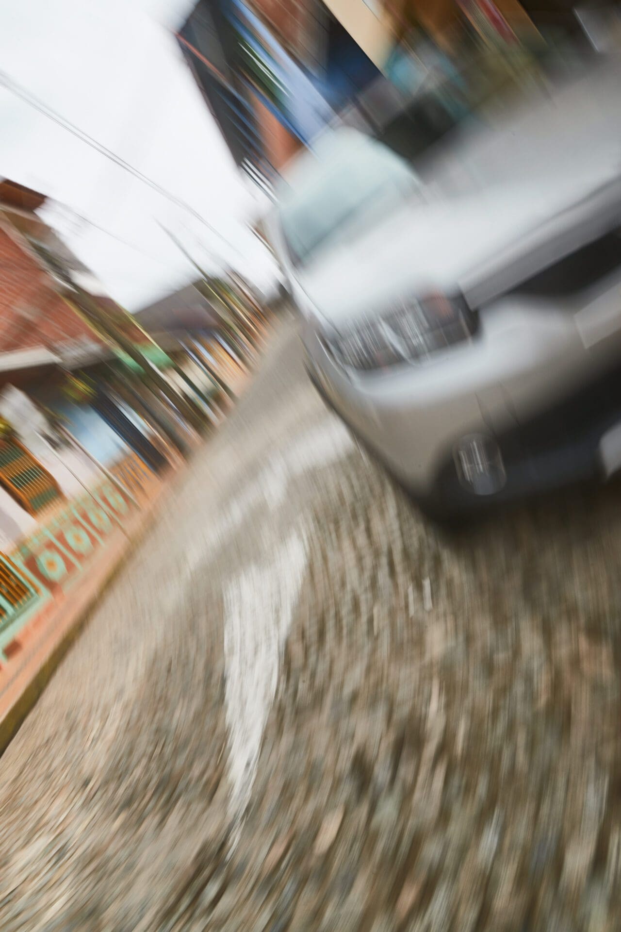 A blurry image of a car driving down a street.