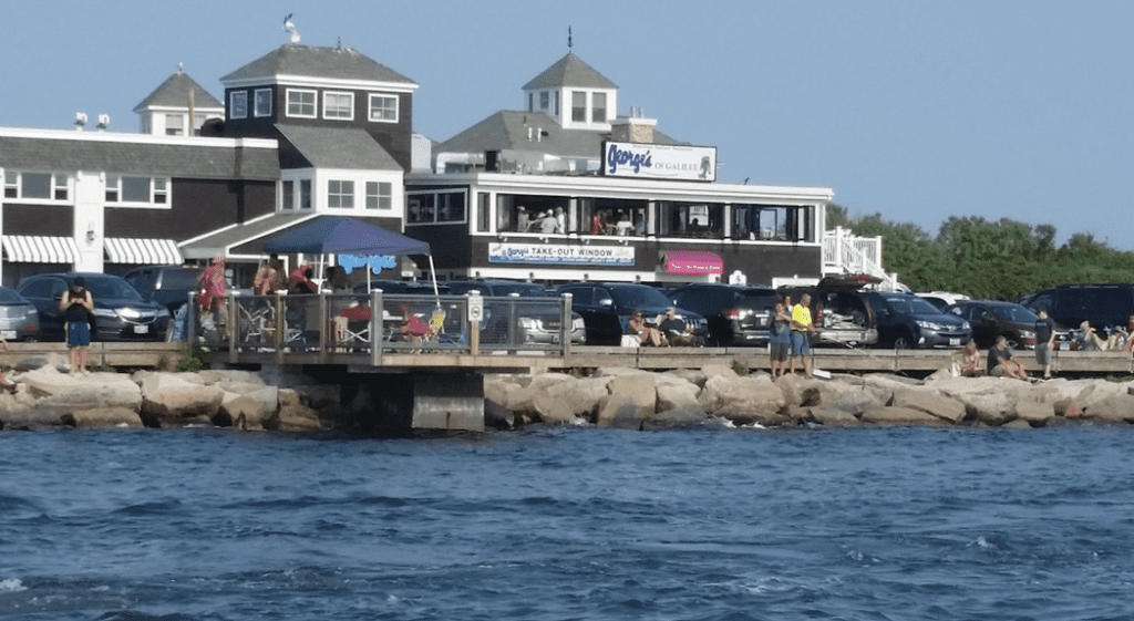 A boat docked next to a building on the water.