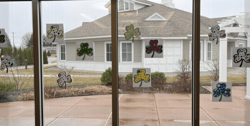 St patrick's day decorations in the windows of a house.