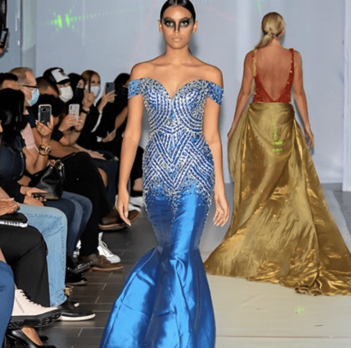 A model walks the runway in a blue gown.