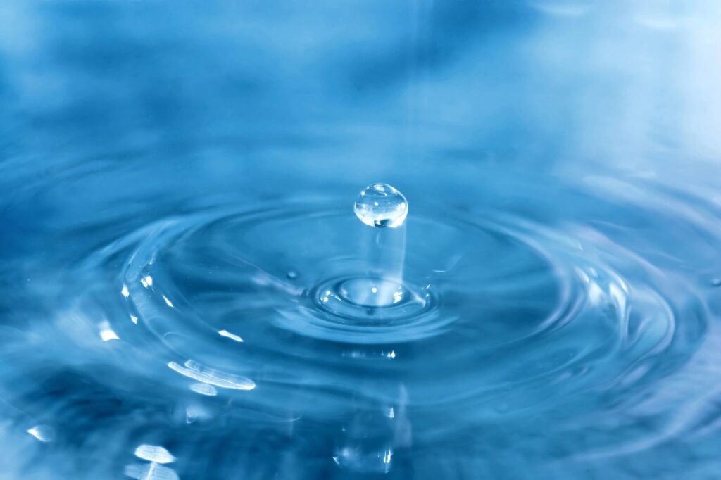 A drop of water on a blue background.