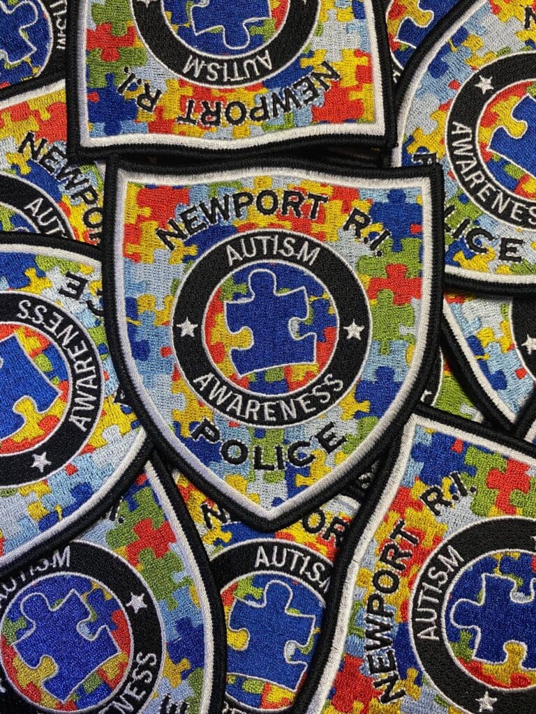 A pile of patches with the word autism on them.