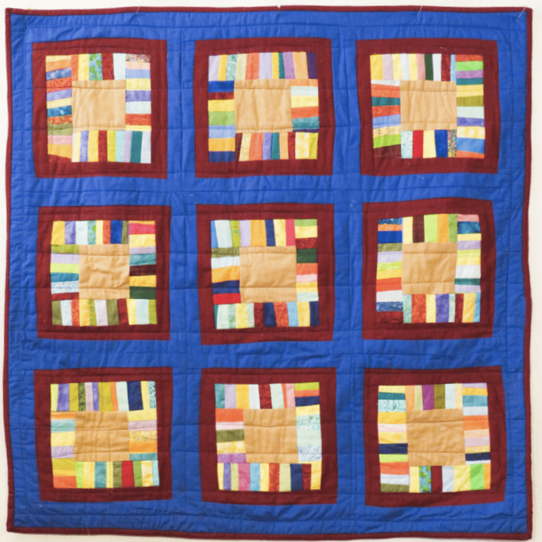 A quilt with squares of different colors.