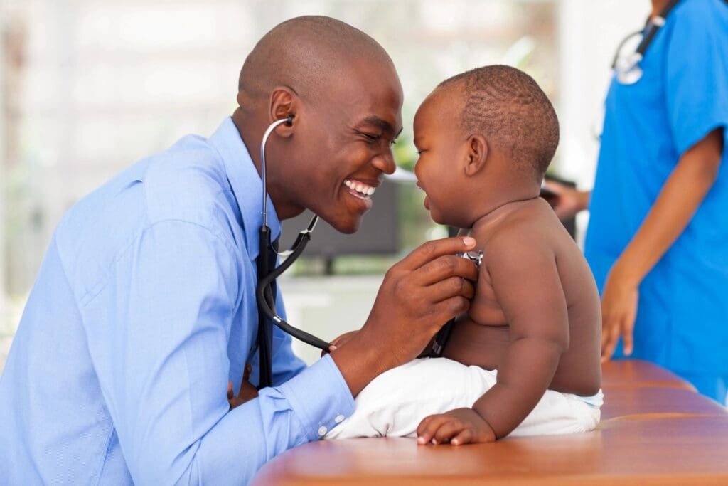 A young boy is being examined by a doctor with a stethoscope.