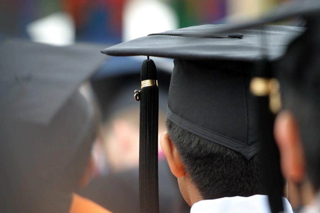 A group of graduates wearing graduation hats.