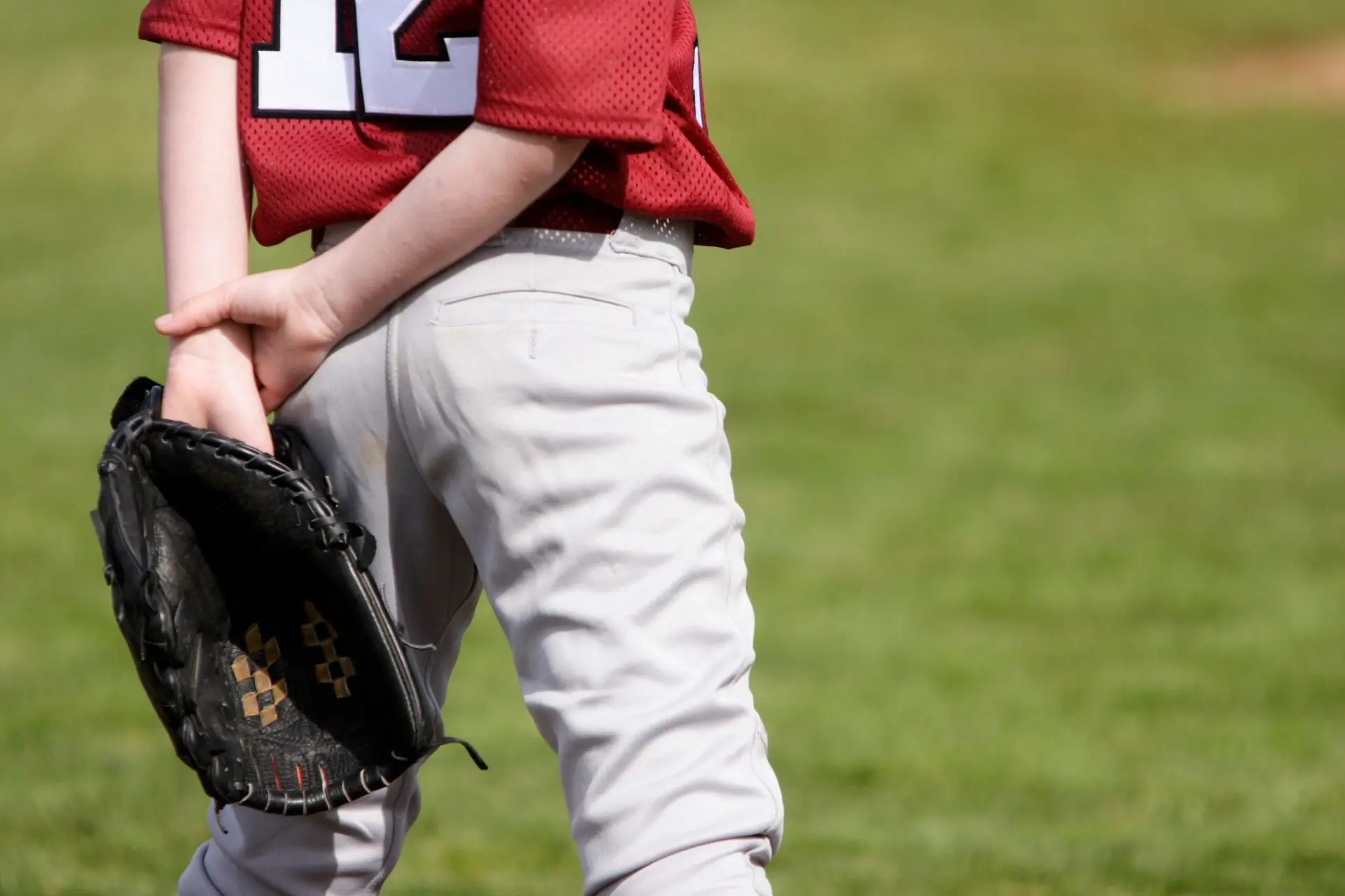 A boy wearing a baseball mitt.