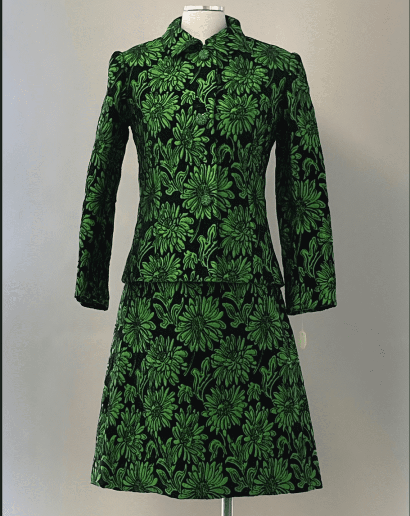 A green floral dress on a mannequin.