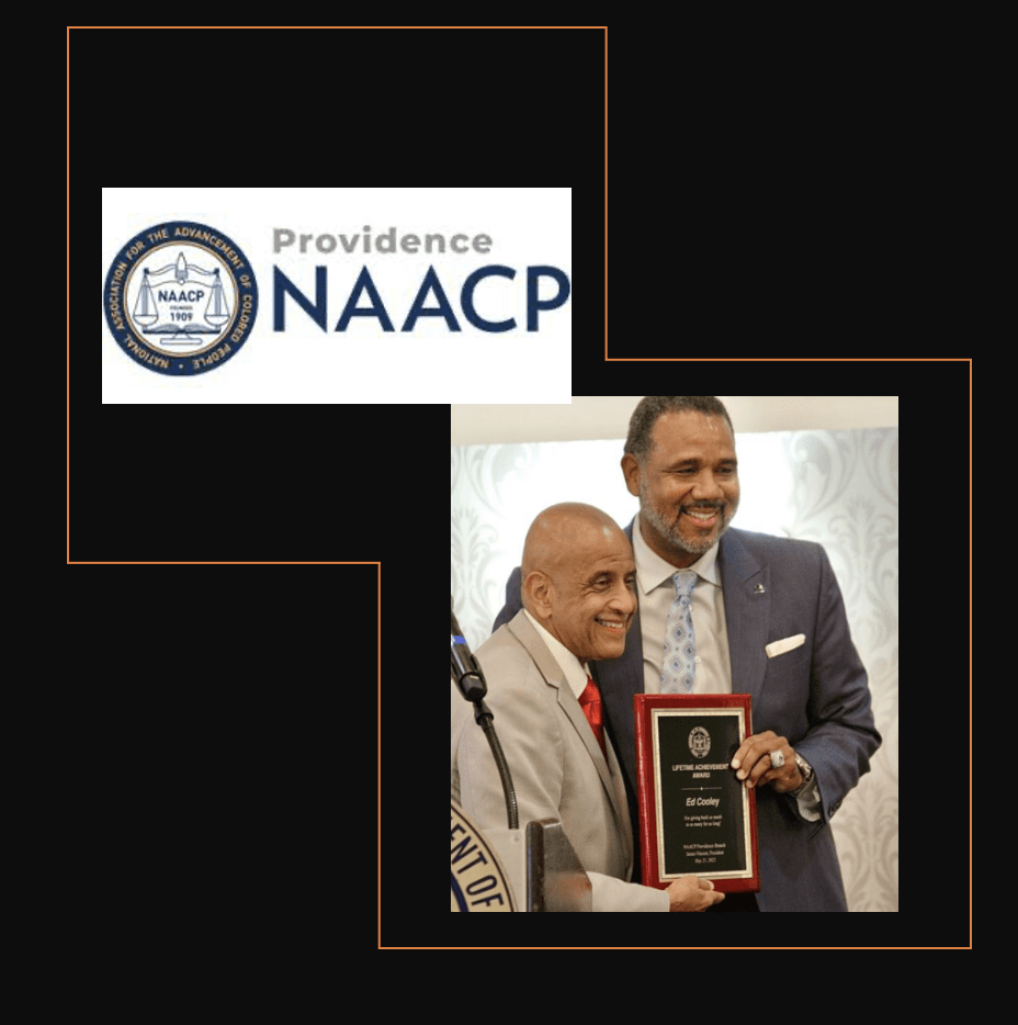 A man in a suit is holding an award from the naacp.