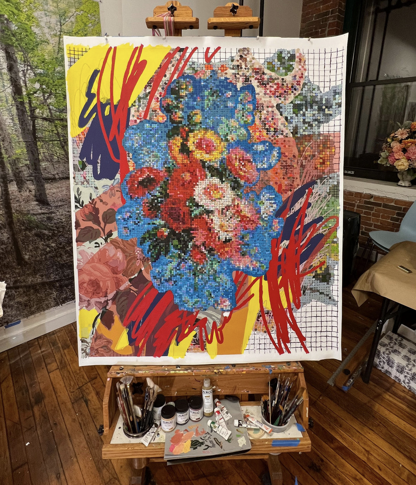 A painting of flowers on an easel in a studio.