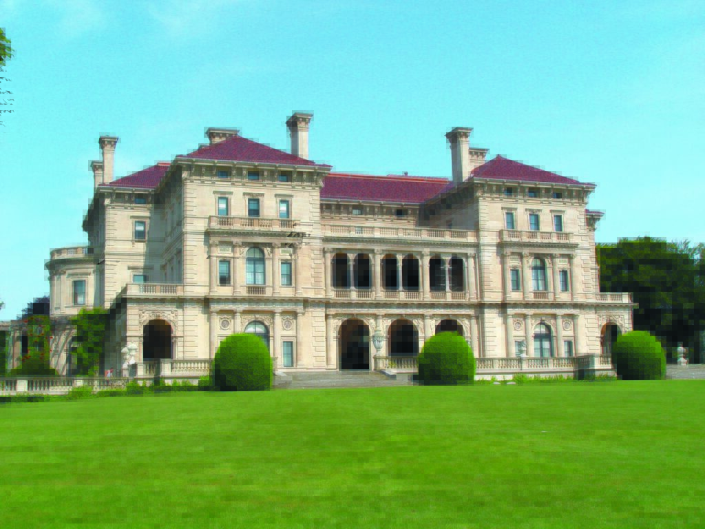 A large mansion on a green lawn.