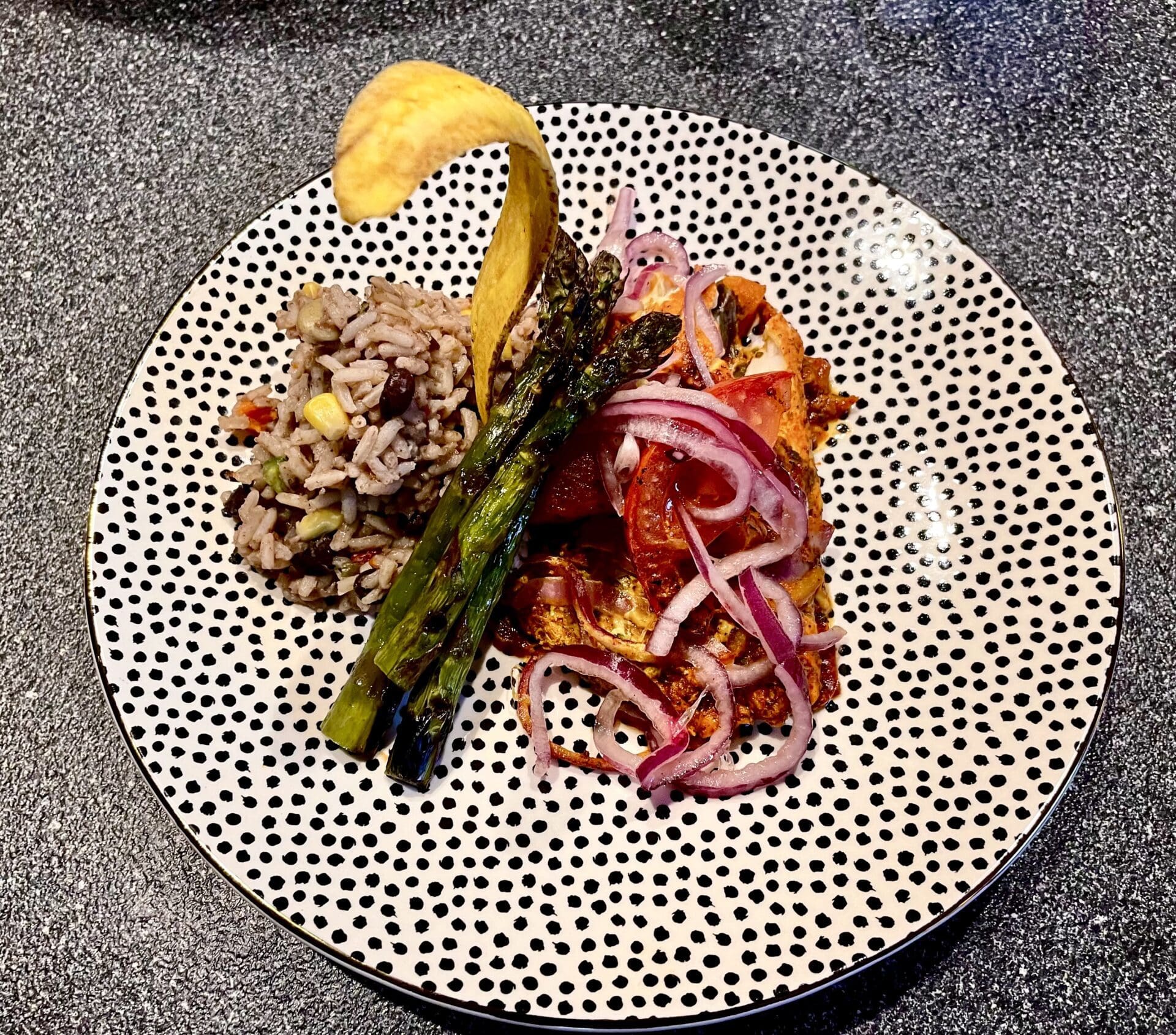 A plate with asparagus and rice on it.