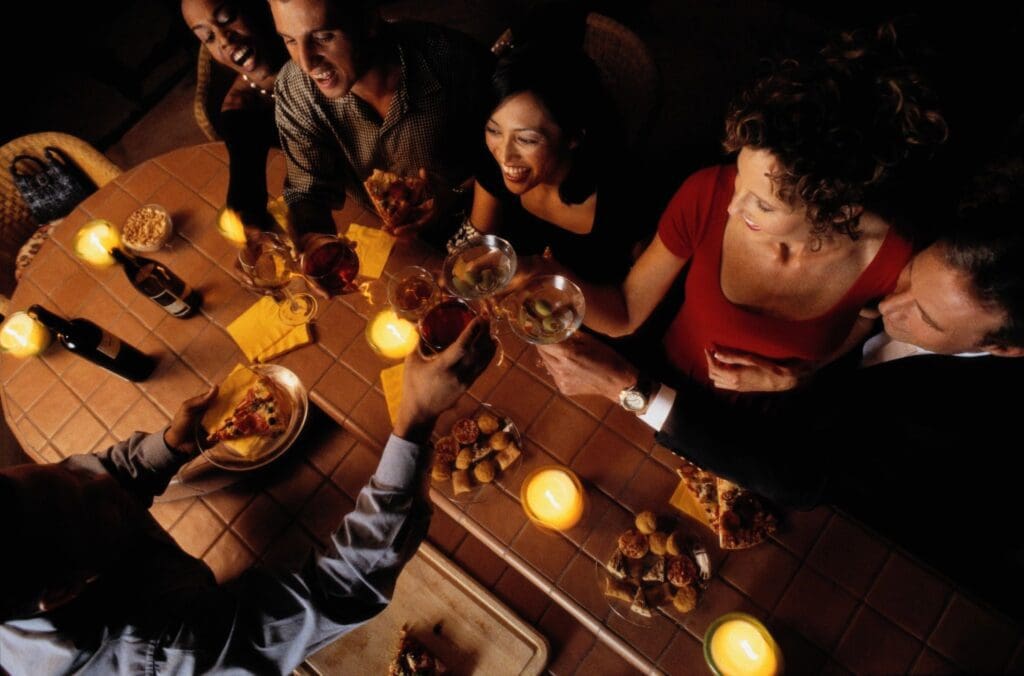 A group of people toasting at a dinner table.