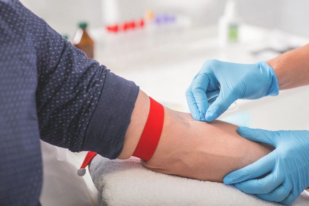 A person is getting a blood test in a doctor's office.