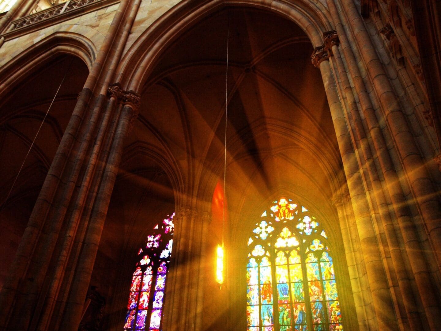 The sun is shining through a window in a cathedral.