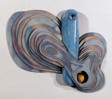 A blue and brown sculpture with a wooden handle.