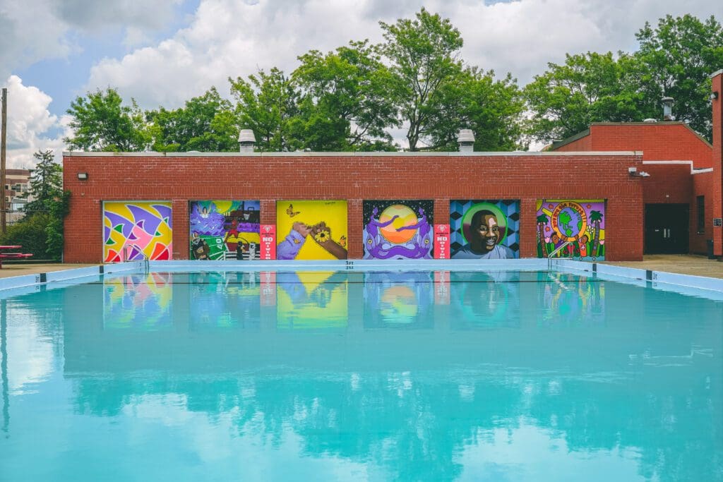 A swimming pool with colorful murals on it.