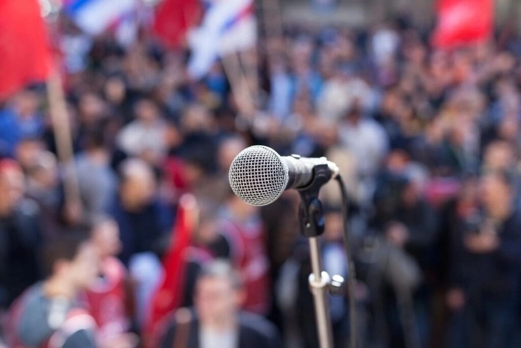A microphone in front of a crowd of people.