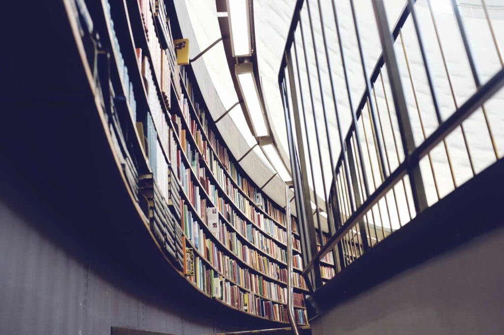 A library with a spiral staircase and bookshelves.
