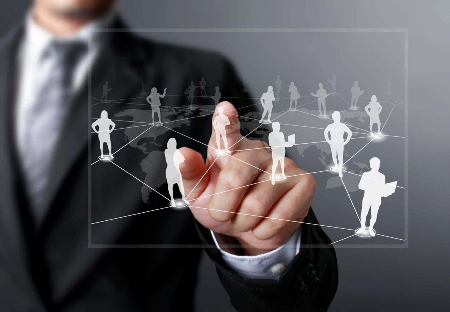 A businessman is pointing at a network of people.