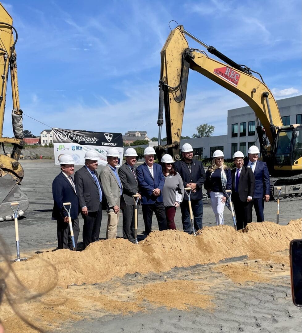 A group of people standing in front of a construction site.