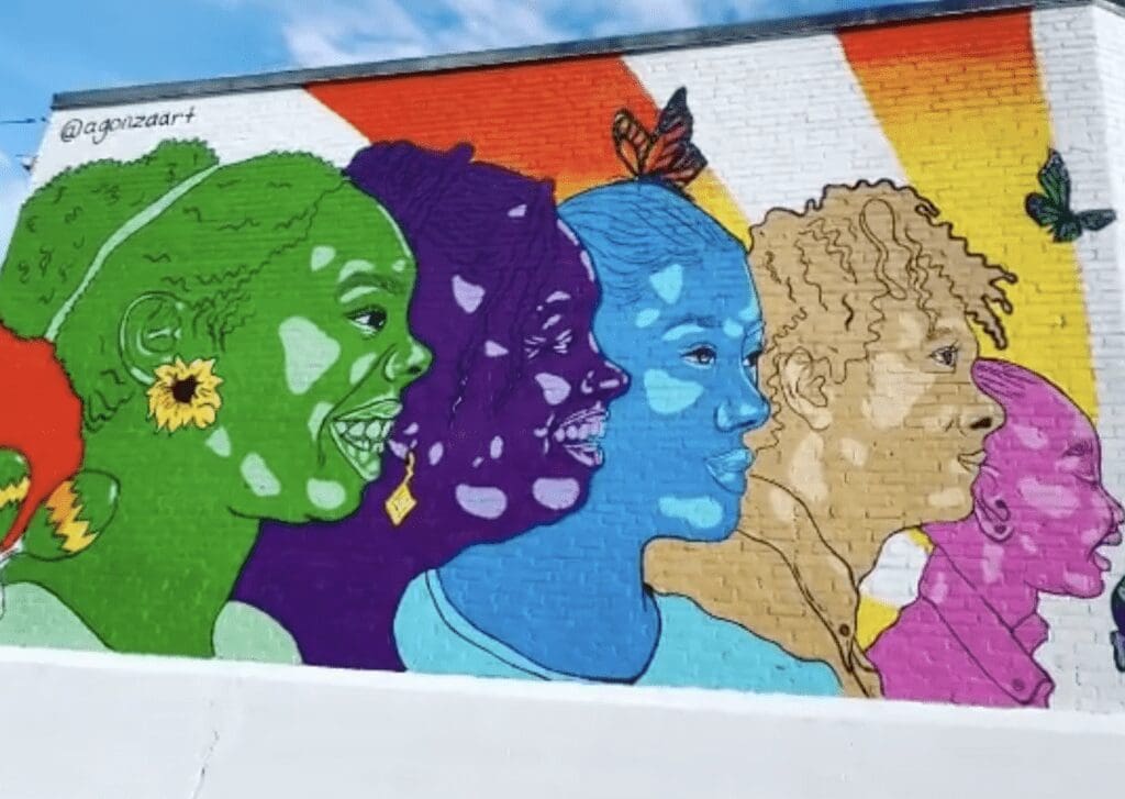 A colorful mural depicting a group of people.