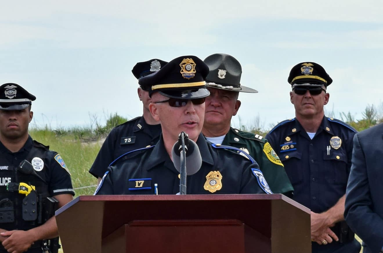 A group of police officers standing at a podium.