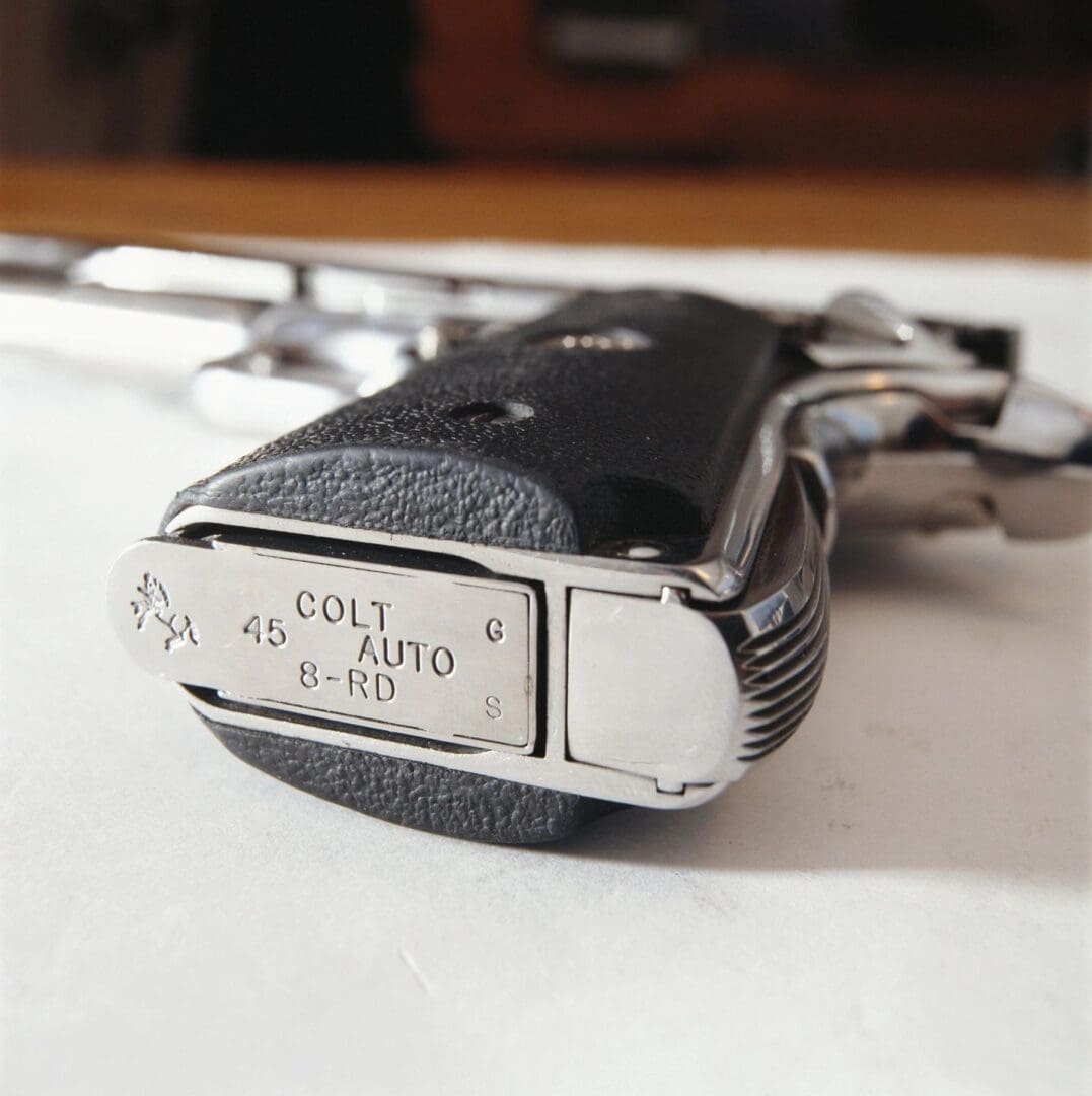 A gun with a tag on it sitting on top of a table.