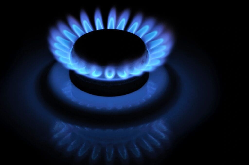 A blue gas flame on a black background.