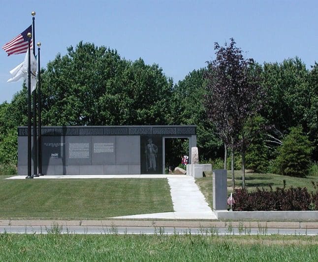 A small building with an american flag in front of it.