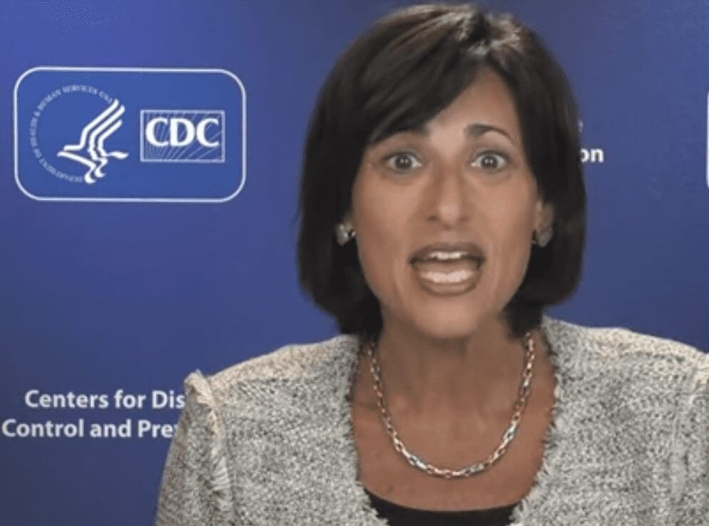 A woman in front of a blue background in front of a cdc logo.