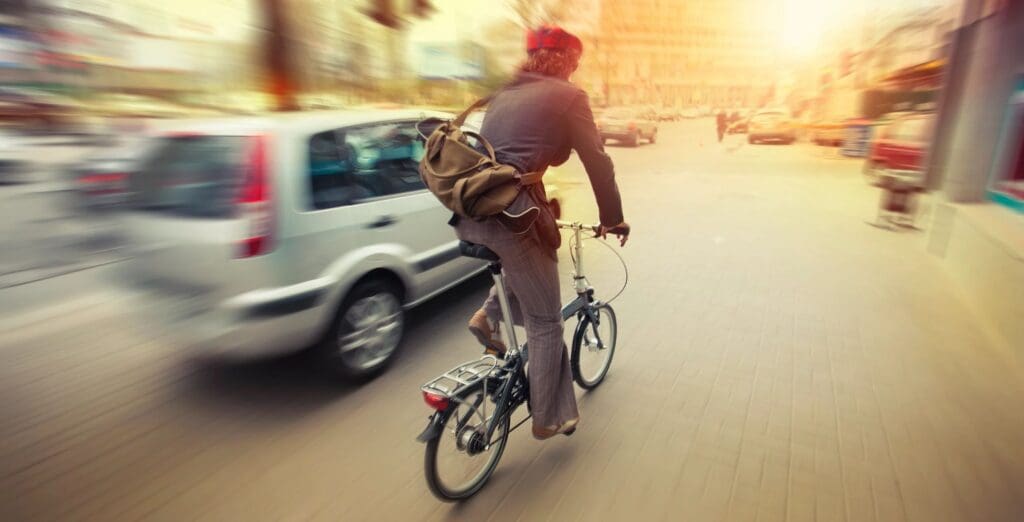 A man riding a bicycle on a city street.