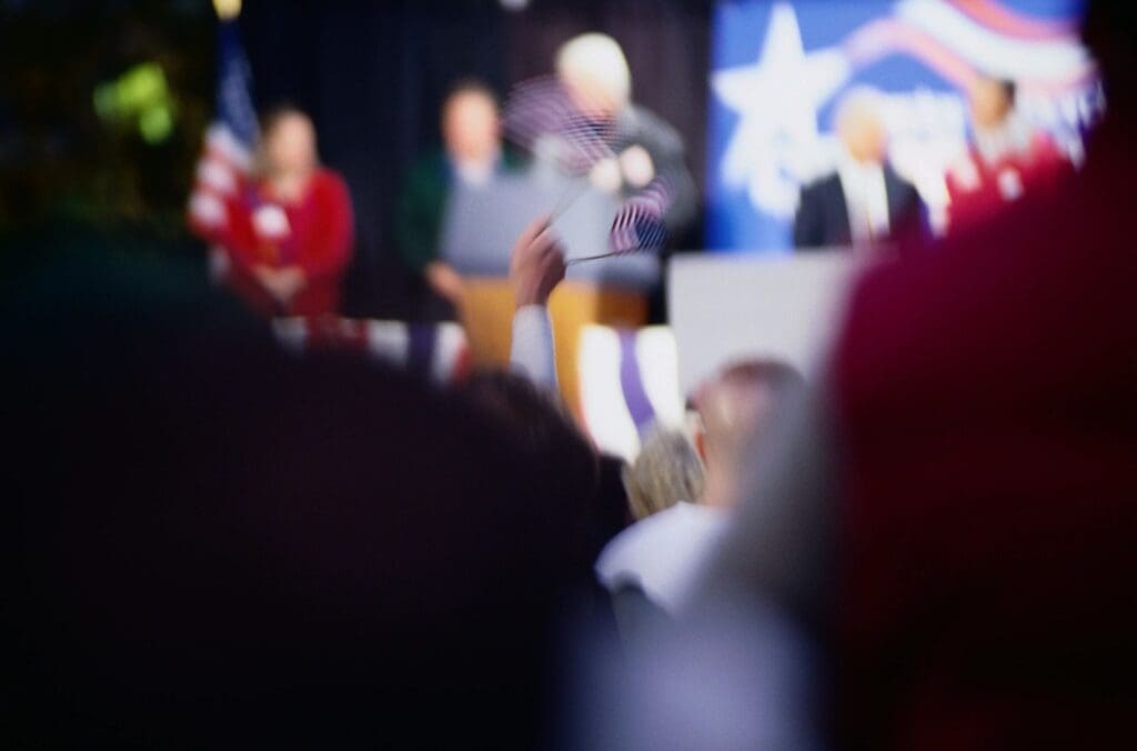 A blurry image of a crowd at a political event.