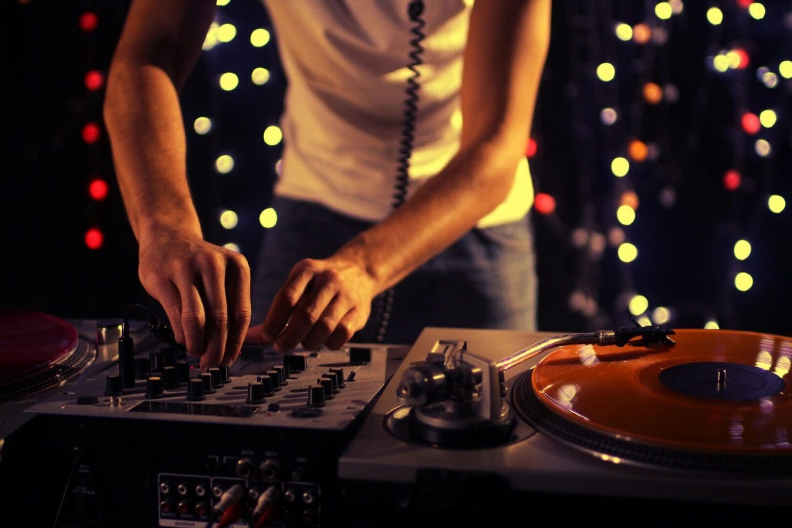 A dj is mixing music on a turntable.