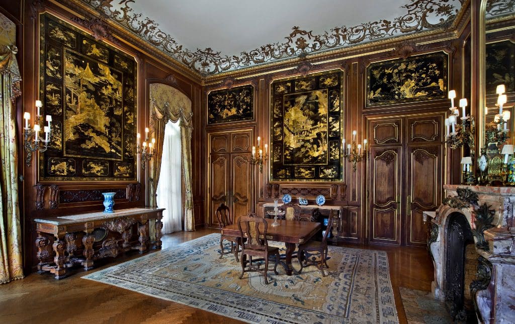 An ornate room with ornate panels and a fireplace.