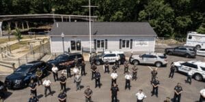 A group of police officers standing in front of a building.