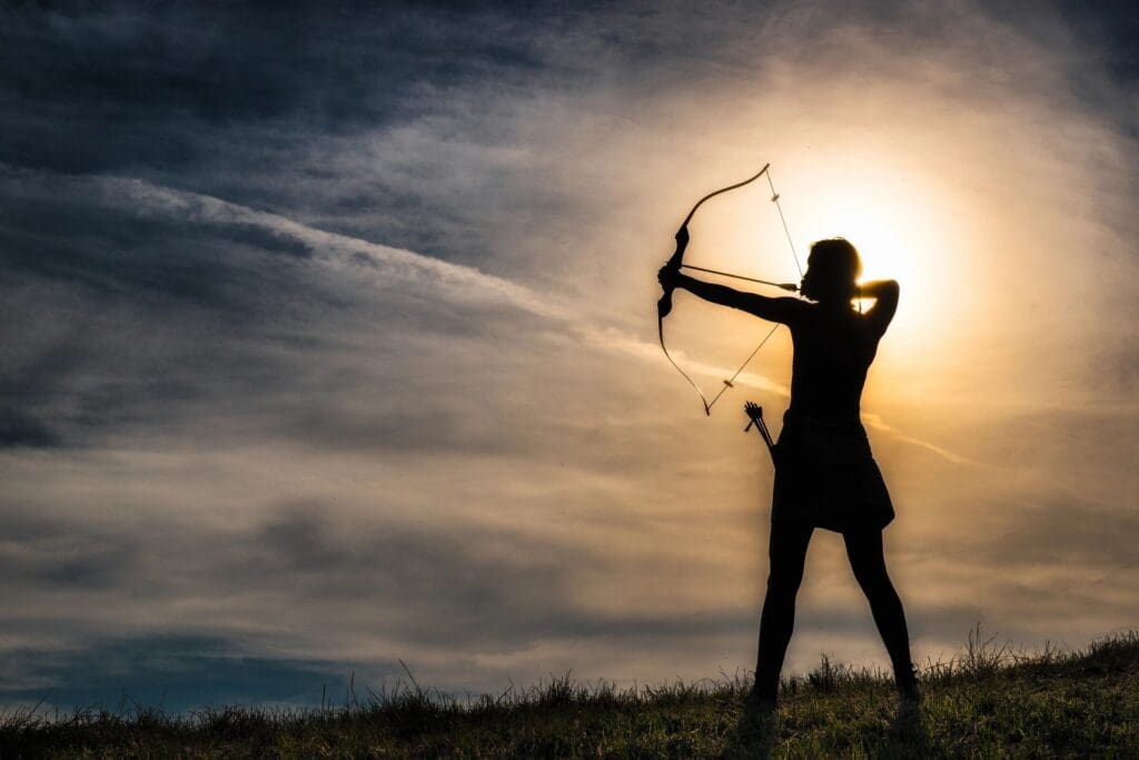 A silhouette of a woman with a bow and arrow.