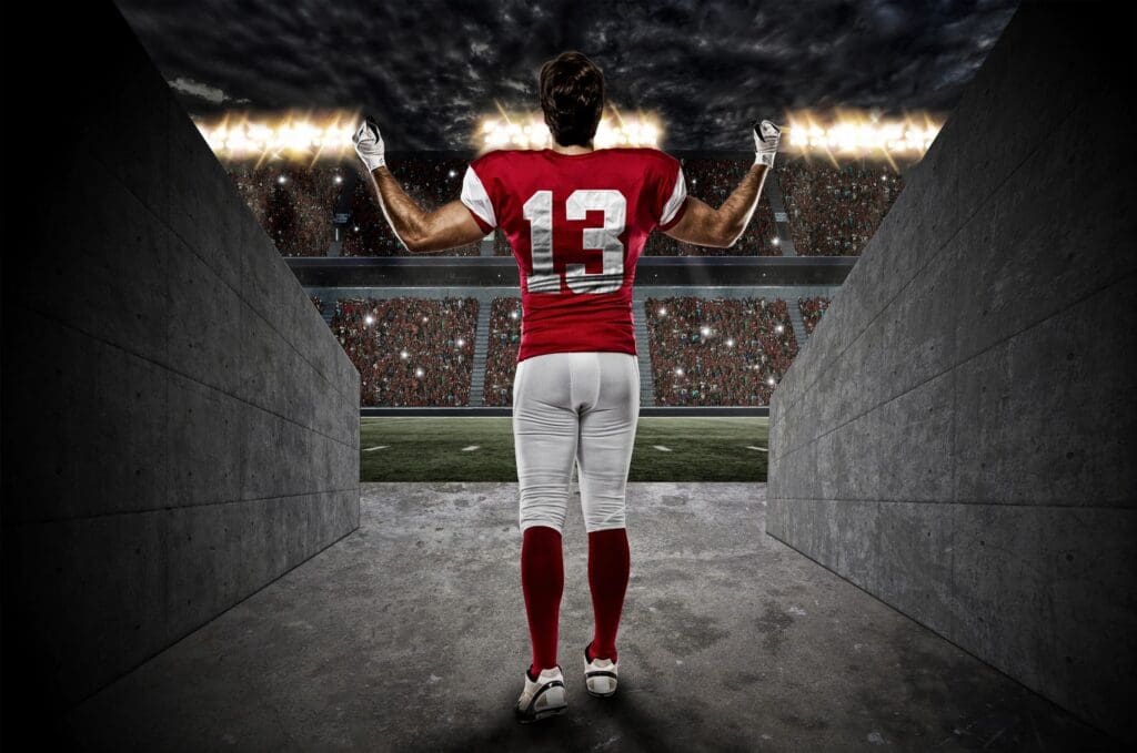A football player standing in an empty stadium.